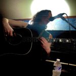 An odd angle of Rhe on guitar