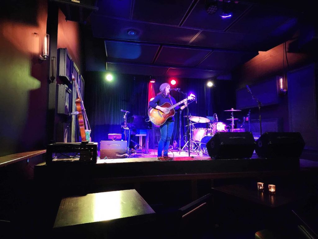 Rhee with Guitar on Stage