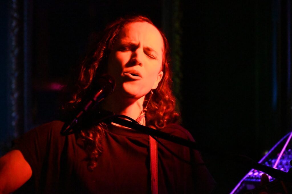 A closeup of Rheannon singing live